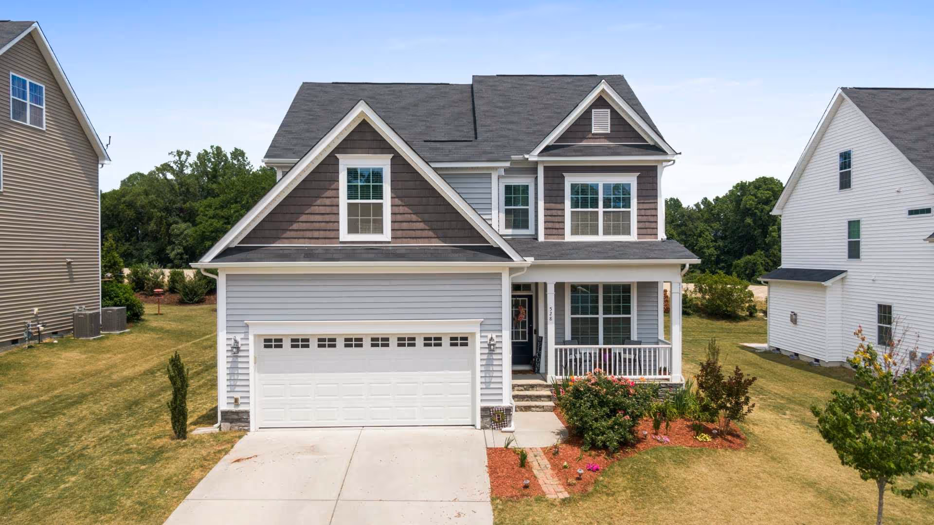 photo of a suburban two-story single family home with a nice yard