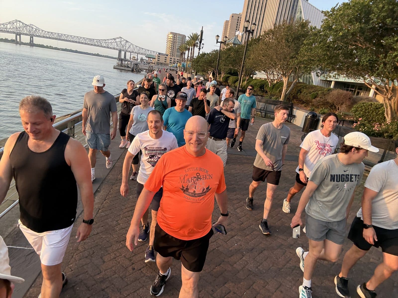 Runners along the riverfront at sunrise